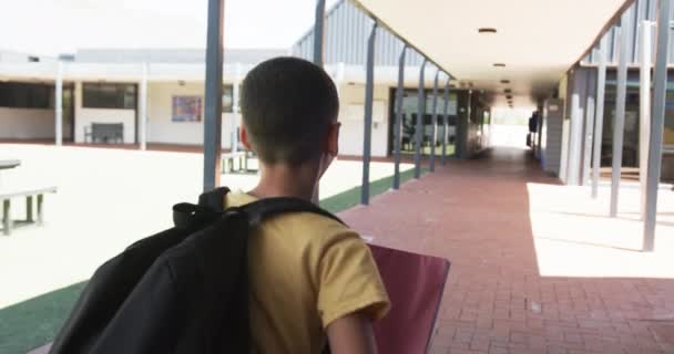 Biraciale Jongen Met Een Rugzak Staat Een Schoolgang Zijn Korte — Stockvideo