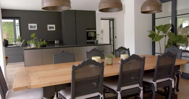 Modern Kitchen Wooden Dining Table Black Chairs Large Pendant Lights — Stock Video