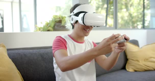 Young Asian Student Engaged Virtual Reality Game Using Headset Home — Stock Video
