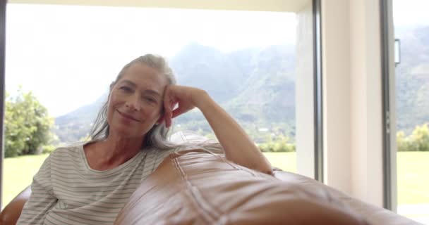 Uma Mulher Caucasiana Madura Relaxa Sofá Casa Sorrindo Satisfeita Com — Vídeo de Stock