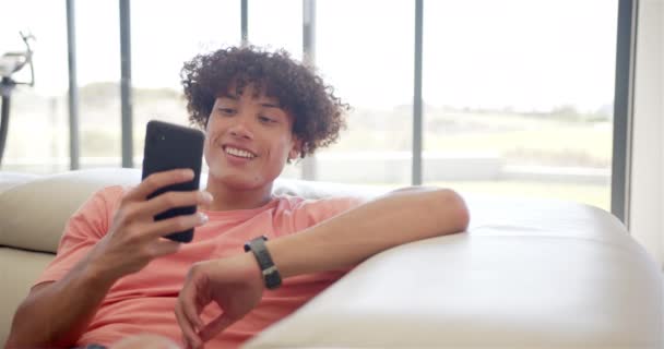 Young Biracial Man Engrossed His Smartphone While Relaxing Couch Home — Stock Video