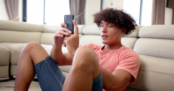 Young Biracial Upset Stressed Man Curly Hair Seated Holding Smartphone — Stock Video