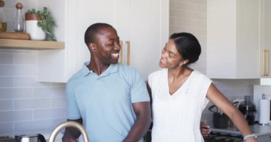 Çeşitli bir çift mutfakta bir anı paylaşıyor, hediyelerle şaşırtıyorlar. Afro-Amerikalı adam elinde kırmızı bir gül tutan İspanyol kadına gülümsüyor. İkisi de gelişigüzel giyinmiş, değiştirilmemiş, ağır çekimde..