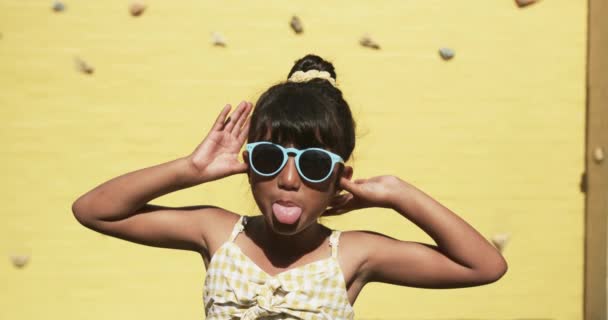 School Setting Young Biracial Student Poses Playfully Yellow Background She — Stock Video