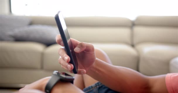 Ένας Νεαρός Χρησιμοποιεί Ένα Smartphone Στον Καναπέ Στο Σπίτι Έχουν — Αρχείο Βίντεο