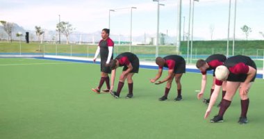 Erkek hokey oyuncuları antrenmandan önce sahada ısınıp ısınıyorlar. Spor, takım çalışması, sporcular, antrenman, egzersiz, hazırlık