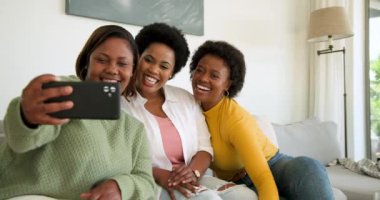 Birlikte gülüyoruz, arkadaşlar oturma odasında akıllı telefondan bir şeyler izliyorlar. Arkadaşlık, eğlence, kahkaha, teknoloji, bağlanma, rahatlama.