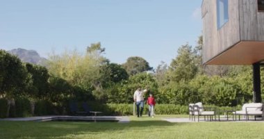 Arka bahçede birlikte oynayan Hintli baba ve küçük oğlu açık havada güneşli bir günün tadını çıkarıyorlar. Aile, yakınlaşma, oyun zamanı, eğlence, güneş ışığı, ebeveynlik