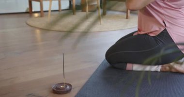 Oturma odasında meditasyon, artı yoga yapan boyunda bir kadın, kopya odası. Sağlık, farkındalık, fitness, sağlıklı, teknoloji, rahatlama