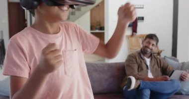 Hintli baba gülerken sanal gerçeklik oyunu oynayan bir çocuk. oyun, teknoloji, aile, eğlence, eğlence, bağ