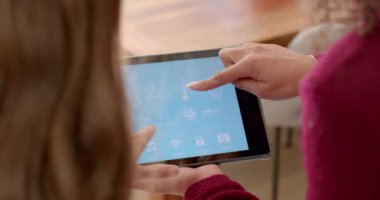 Tablet tutmak, kadınlar oturma odasında akıllı ev ortamlarını birlikte idare etmek. Teknoloji, yönetim, takım çalışması, aygıt