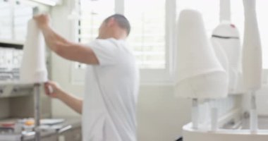 Protez laboratuarındaki teknisyen yapay uzuv üzerinde çalışıyor, bileşenleri ayarlıyor. Mühendislik, teknoloji, sağlık, ortopedi, yenilik, uzmanlık