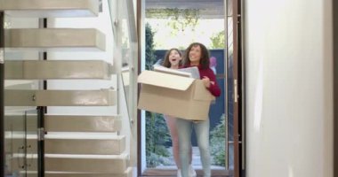 Karton kutu taşıyorlar, mutlu lezbiyen çift yeni evine taşınıyor. Taşınma, boşaltma, mutluluk, çeşitlilik, gülümseme.