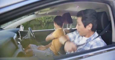 Araba sürmeyi öğrenen Asyalı genç adam araba eğitmeninden talimat alıyor. Sürücü, eğitmen, öğrenci, ders, rehber, otomotiv
