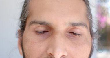Kapalı gözlü, evde dinlenen ve meditasyon yapan bir adam. Meditasyon, rahatlama, farkındalık, sükunet, barış, zen