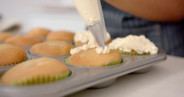 Kekleri kremayla süslemek, mutfakta boru torbası kullanmak. Pişirme, pasta, tatlı, aşçılık, krema, tatlı