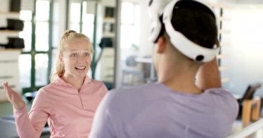 Engelli rehabilitasyonunda, kadın gülümserken erkek terapi için VR kulaklığı kullanıyor. rehabilitasyon, sağlık hizmetleri, sanal gerçeklik, gülümseme, olumlu, destek, değiştirilmemiş, yavaş çekim