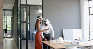 VR kulaklıkları kullanarak, çeşitli meslektaşlar ofisteki mimari projede işbirliği yapıyorlar. İşbirliği, teknoloji, mimari, takım çalışması, yaratıcılık, yenilik