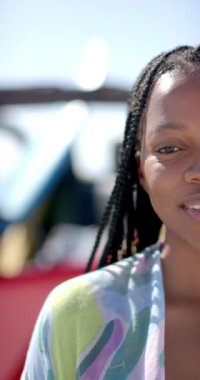 Dikey video: Gülümseyen kadın güneşli bir günde açık hava gezisinden hoşlanıyor, yakın plan portre. Seyahat, macera, özgürlük, açık hava, mutluluk, yaşam tarzı, yavaş çekim