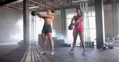 Kettlebell kaldırmak, spor salonunda antrenman yapan iki kadın. egzersiz, egzersiz, güç, takım çalışması, sağlıklı yaşam tarzı, fiziksel kondisyon