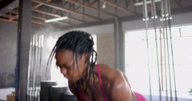 Kettlebell 'i kaldırmak, spor salonunda güçlü antrenmanlara odaklanan bir kadın. Fitness, egzersiz, kas, dayanıklılık, motivasyon, sağlık