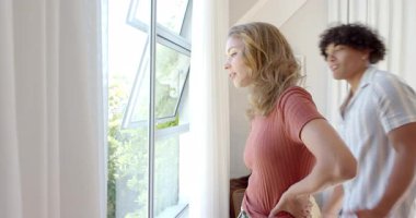 Pencerenin kenarında birbirine sarılan çeşitli çiftler güneşli bir günün ve güzel bir açık hava manzarasının tadını çıkarıyorlar. Romantizm, şefkat, sıcak, güneş ışığı, kucak, sükunet