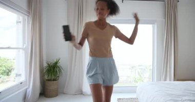 Evde dinlenen, yatağa uzanmış, huzurlu anın tadını çıkaran bir kadın. Rahatlama, sükunet, rahatlık, konfor, yaşam tarzı, huzur