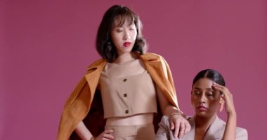 Çerçeveye giren çeşitli kadın modeller stüdyodaki pembe sandalyede ikiz modeller oluşturuyorlar. Zarafet, koordinasyon, moda, profesyonellik, minimalizm, özgüven, sinerji