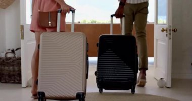 Çeşitli çiftler tatilin tadını çıkarıyorlar, modern otel odasında, pencerenin kenarında bavullarıyla bekliyorlar. Seyahat, turizm, konukseverlik, tatil, kaçamak, rahatlama