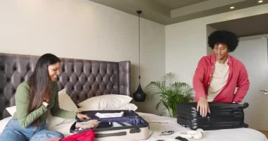 Çeşitli çiftler bavullarını toplamaya hazırlanıyor gömlekleri, çorapları, şapkaları ve kulaklıkları ayırıyorlar. Seyahat, paketleme, organizasyon, yaşam tarzı, yerli, gündelik, uyum