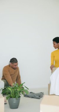 Dikey video: Kutuları açmak, fabrika açmak ve kazakları katlamak, yeni bir eve yerleşmek. Yurt içi, işbirliği, rahat, minimalizm, yaşam tarzı, bağlantı, dikey video