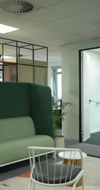 Dikey video: Kamera başlangıçta yeşil kanepe ve toplantı odasını gösteriyor. Modern, kurumsal, iç mekan, çalışma alanı, işbirlikçi, stil, dikey video