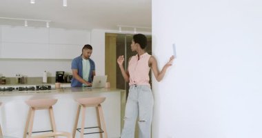 Çeşitli çiftler duvarlara dokunuyor ve renk seçmek için mutfaktaki kumaş örneklerini karşılaştırıyor. Boşluğu kopyalayın. Modern, ambient, minimalist, yaşam tarzı, iç mekan, işbirlikçi, yaratıcı