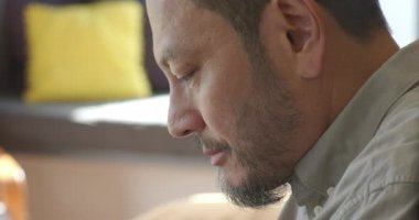 Kıdemli Asyalı adam toplanıyor, stil seçiyor, telefon çalıyor, yatağa not defteri yazıyor, fotokopi çekiyor. Konsantrasyon, farkındalık, teknoloji, üretkenlik, rahatlama, minimalizm, çalışma alanı