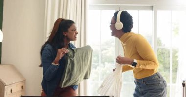 Çeşitli bayan arkadaşlar tartışıyorlar, yeşil bluzlar giyiyorlar, seyahat için yatak odasındaki bavullara dantelli bluz takıyorlar. Yoldaşlar, macera, seyahat, organizasyon, gündelik, yaşam tarzı, arkadaşlık