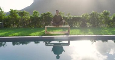 Sabah güneşi dağların ardında parıldıyor, Asyalı kadınlara ilham veriyor teras banklarında havuz başında meditasyon yapıyor. Dinginlik, sağIık, sükunet, minimalizm, doğa, farkındalık, rahatlama