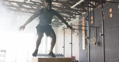 Afrika kökenli Amerikalı erkek spor salonunda güç için plyometrik kutuya atlamadan önce zihinsel hazırlık yapıyor. Sporcu, güç, antrenman, kondisyon, fitness, güç, çeviklik