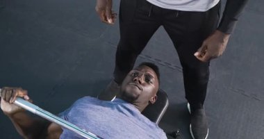 Spor salonunda ağırlık kaldırma halterini gözcüyle ezip güç topladıktan sonra. Güç, zindelik, antrenman, atletik, kararlılık, motivasyon, güç