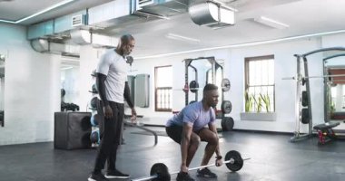 Spor salonundaki Afrikalı Amerikalı antrenör ve müvekkil halter bitirme temsilcisini kaldırıyor. Fitness, strength, training, motivasyon, spor salonu, egzersiz, sağlık