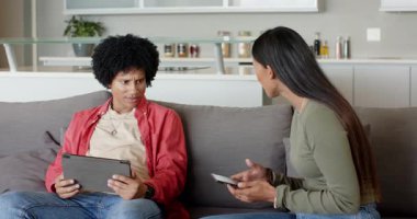 Afro-Amerikalı erkek tableti, mutfak adası tartışmasına katılan Hintli kadın olarak kaydırıyor. Teknoloji, iletişim, çoklu görev, modern, etkileşim, yerli, yaşam tarzı