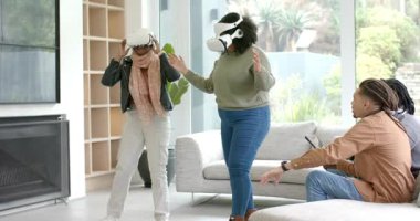 Kadın arkadaşlar spor olsun diye VR kulaklıklarını yerleştiriyor, evde tablet tıkırdatan arkadaşları taklit ediyorlar. Teknoloji, yenilik, sanal gerçeklik, refah, aktivite, etkileşim, modern