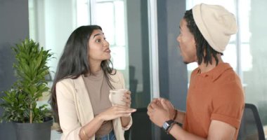 Çeşitli iş arkadaşları fabrikanın yanındaki ofiste seramik bardak paylaşımı ile karşılama yapıyor, tepki veriyorlar. İşbirliği, iletişim, etkileşim, profesyonel, modern, çalışma alanı, çeşitlilik