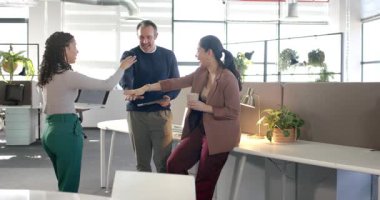 Masada tablet çizelgesini sunan çeşitli iş arkadaşları ellerinizi başınızın üstüne koyarak büyümeyi kutluyorlar. İşbirliği, takım çalışması, modern ofis, profesyonel, yenilik, çeşitlilik, başarı