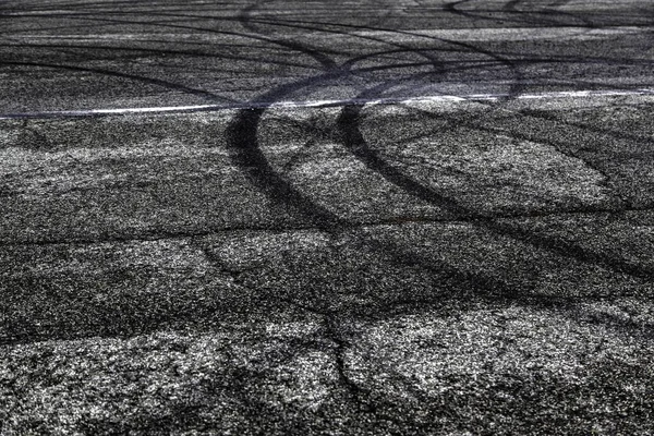 Detail of wheel marks on a mountain road, clandestine car race