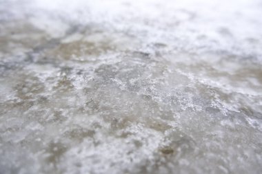 Detail of cold winter day, frost and freezing of water in the street