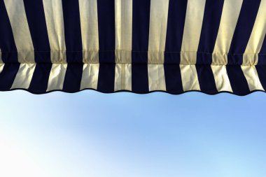 Detail of fabric awning to protect from the sun clipart