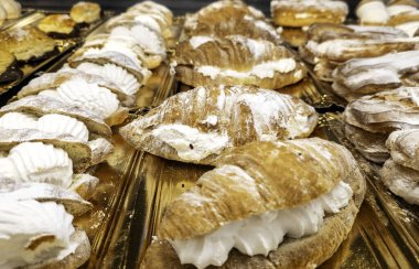 Restoranlarda, tatlılarda ve kutlamalarda profiteroller kremayla dolu.