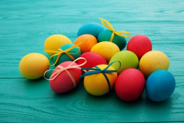 colorful easter eggs top view on blue chalkboard copy space