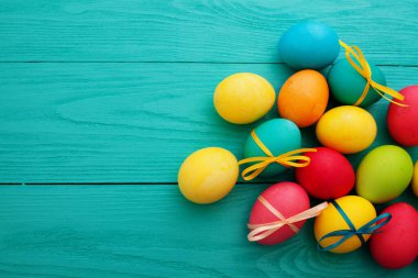 colorful easter eggs top view on blue chalkboard copy space