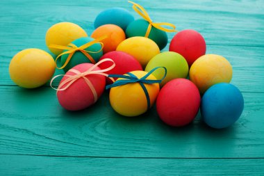 colorful easter eggs top view on blue chalkboard copy space